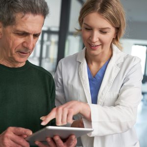 Doctor showing patient tablet